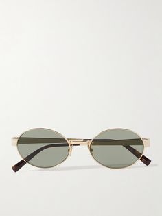 SAINT LAURENT Eyewear's oval-frame sunglasses have an impossibly cool, retro feel - it's easy to imagine the frontwoman of a rock band wearing them in the '60s. They're made from gold-tone metal with smoky lenses and tortoiseshell acetate arms. Planned Outfits, Classy Jewellery, Classy Glasses, Sunglasses Luxury, Saint Laurent Sunglasses, Classic Sunglasses, Sunglass Holder, Raffia Bag, Classy Jewelry