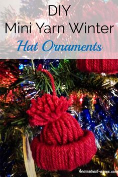 an ornament hanging from the top of a christmas tree with text overlay that reads diy mini yarn winter hat ornaments