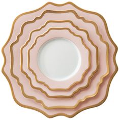 pink and gold plates stacked on top of each other