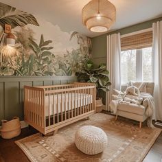 a baby's room with a crib, rocking chair and large painting on the wall