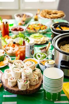 a green table topped with lots of food