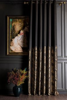 a vase with flowers sitting in front of a painting on the wall next to a window