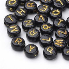 several black and gold typewriters are scattered on a white surface with the letters spelled out