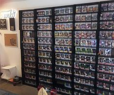 a room filled with lots of different types of video games on the wall next to each other