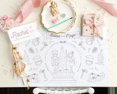 a table topped with lots of different items on top of a white plate and pink ribbon