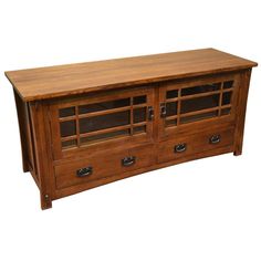 a wooden entertainment center with glass doors on the top and bottom drawers, in front of a white background