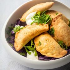 a white bowl filled with food on top of a table