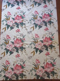 a large floral wall hanging on a wooden floor