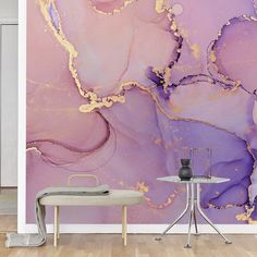 an artistic wall mural with purple and gold paint on it's walls in a living room