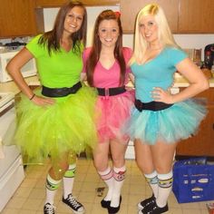 three women dressed up in costumes posing for the camera