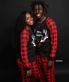 two people in matching pajamas posing for the camera