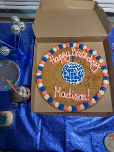 a birthday cake with the words happy birthday madison in pink, blue and white frosting