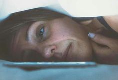 a close up of a person laying in bed