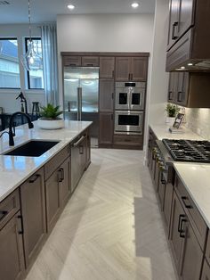 a kitchen with marble counter tops and stainless steel appliances in the middle of the room