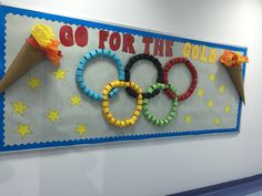 a sign that says go for the gold in front of some olympic rings and ice cream cones