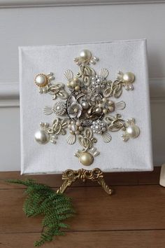 a white napkin covered in pearls and brooches sitting on top of a wooden table