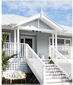 a white house with stairs leading up to it