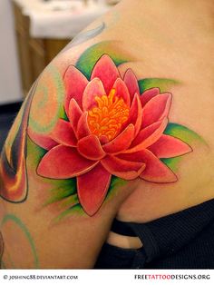 a woman's shoulder with a flower tattoo on it