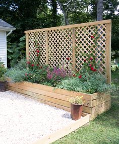 an outdoor garden with flowers and plants growing in the planter boxes on the side