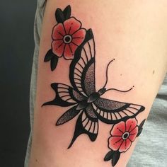 a woman's arm with flowers and a bird tattoo on the left side of her arm