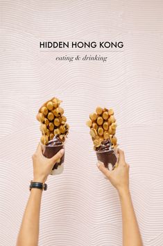 two hands holding small jars filled with nuts and chocolates, the text hidden hong kong eating & drinking