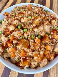 a bowl filled with rice and vegetables on top of a wooden table next to the words bbq pork fried rice