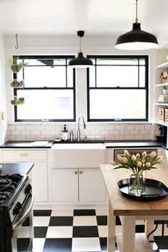 a kitchen with black and white checkered flooring