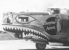 an old airplane with shark teeth painted on it's side and the words surprise attack