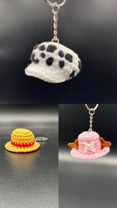 three crocheted hats are hanging from keychains on a black surface, one has a white hat and the other is a pink hat with polka dot