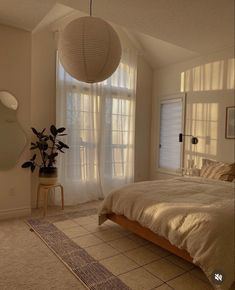 a bedroom with a large bed and white curtains