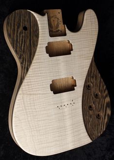 an electric guitar with wood grained body and pick up holes on the back side