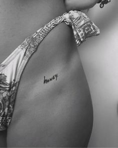 a woman's stomach with the word honey written on it and a tie around her waist