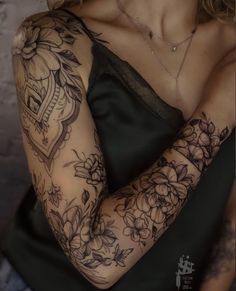 a woman with tattoos on her arm and shoulder