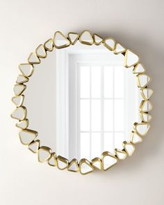 a heart shaped mirror hanging on the wall