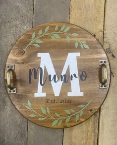 a wooden sign with the letter m painted on it