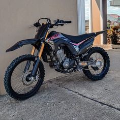 a dirt bike parked next to a building