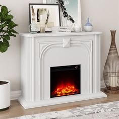 a white fireplace with an electric fire in the middle and a potted plant next to it