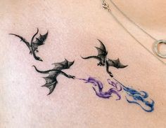 a woman's chest with three flying birds on it