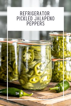 jars filled with pickled jalapeno peppers on top of a wooden table