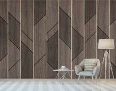 a chair and table in front of a wall with wood paneling on the walls