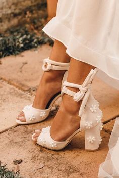 the bride's shoes are adorned with pearls