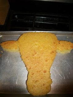 a piece of bread that is shaped like a cow's head on top of a metal pan