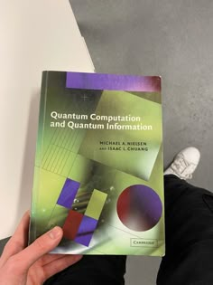 a person holding up a book in front of their face with the title'quanturn computing and quntium information '