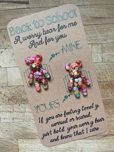 the back to school bear earrings are made from glass beads and have words written on them