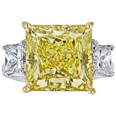 We bring you another Louis Newman & Company creation. If you want something big, shiny and yellow for a great price point, this is it. GIA Certified 11.11 carat princess cut diamond with a VS1 clarity and Natural Fancy Yellow. Mounted in a Platinum and Yellow Gold Setting with 2 princess cut side stones weight 1.01 carats each. GIA report # 2155220043 Yellow Diamond Jewelry, Fancy Yellow Diamond Ring, Radiant Cut Diamond Ring, Yellow Diamond Ring, Contemporary Engagement Rings, Yellow Diamonds, Yellow Diamond Rings, Fancy Yellow Diamond, Modern Engagement Rings