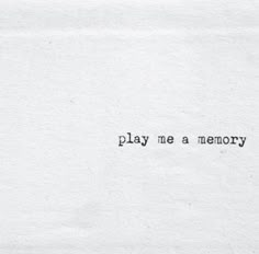 the words play me a memory written in black ink on a white piece of paper