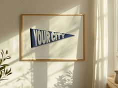 a blue and white sign hanging on the side of a wall next to a potted plant