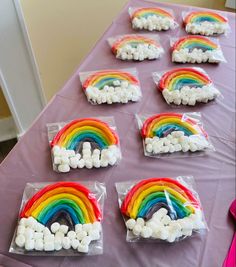 there are rainbows and marshmallows in the bags on the purple table