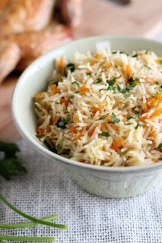 a white bowl filled with rice and carrots