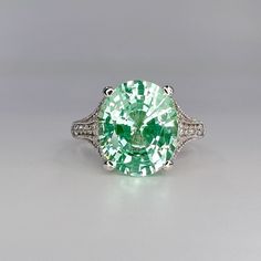 "While Supplies Last! This ring is an oval lab created right green paraiba with round moissanite accents, 14k white gold #6401 -Approximate total carat weight:  6.05ctw diamond equivalent  -Center Stone Size:  12x10mm - approx. 5.80ct diamond equivalent  -Center Stone Shape: oval  -Gem Type:  Lab Created Tourmaline Paraiba Corundum  -Treatment: Nanocrystal -Stone Clarity: VS2 -Stone Color: Light Green/Mint Green -Moh's Scale: 7 Hardness -Side Stones: round  - approx. 0.25ct diamond equivalent -G Esty Finds, Oval Engagement Ring, Soldering Jewelry, Oval Engagement, Green Mint, August Birthstone, Ring Light, Engagement Rings Oval, Round Moissanite